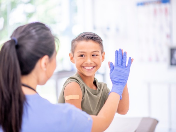 Pharmacist assisting customer at modern pharmacy counter