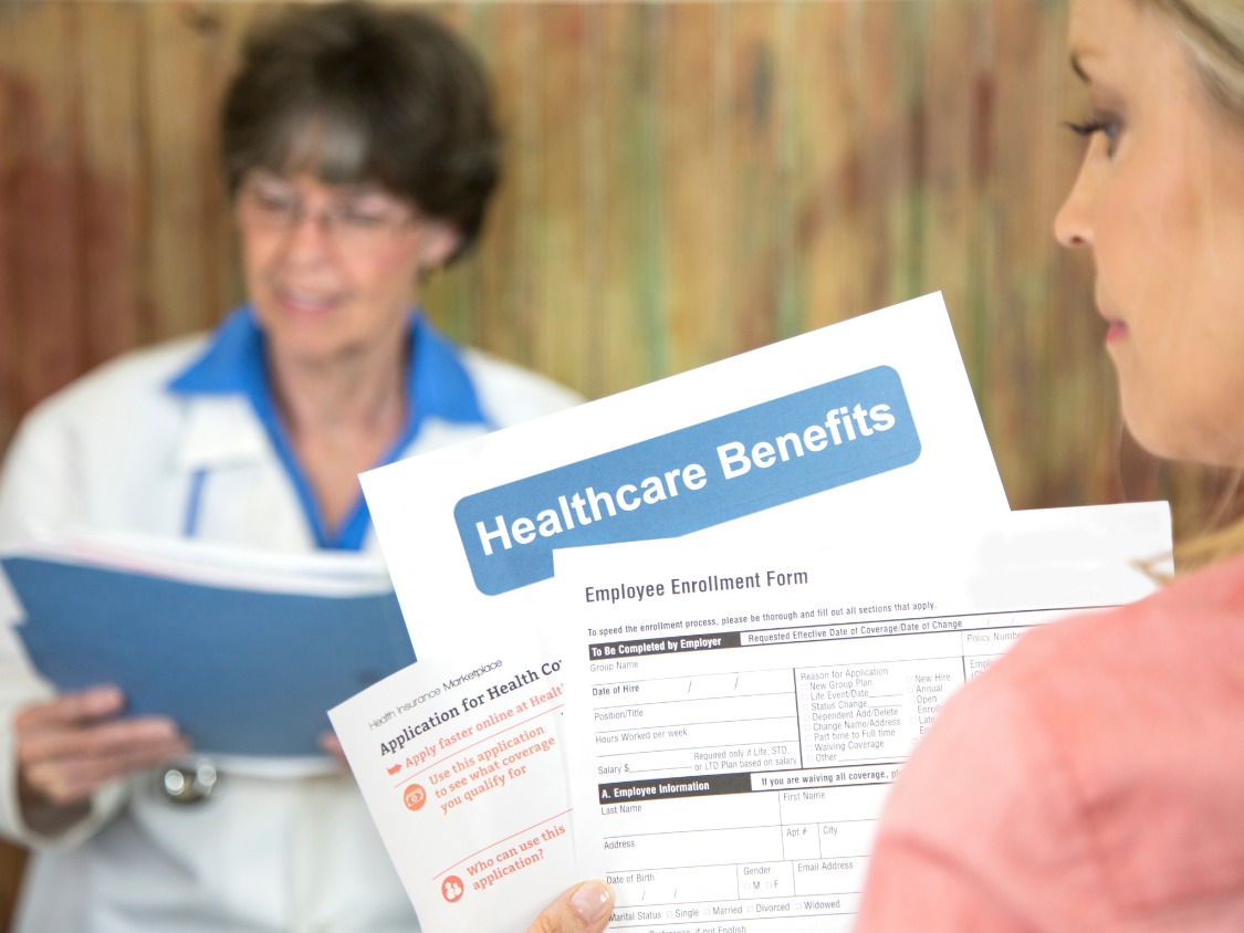 Pharmacist assisting customer at modern pharmacy counter